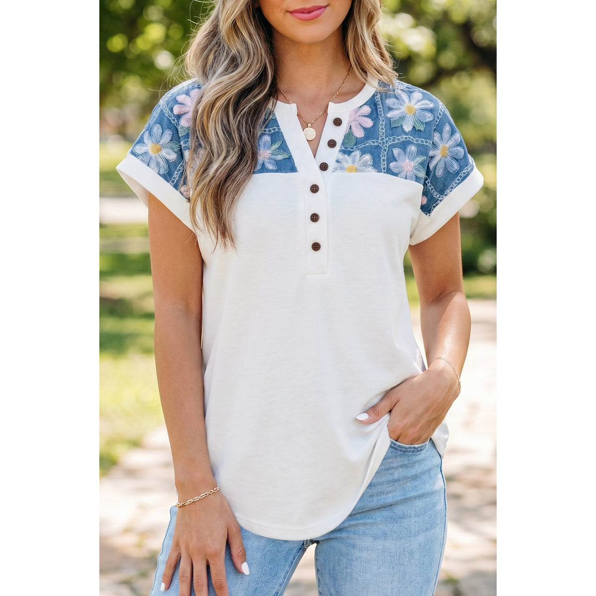 Blusa bianca a maniche corte con inserti floreali — vestibilità sul modello
