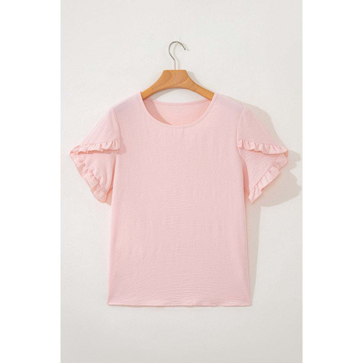 Blusa rosa chiaro con maniche a volant — vista frontale